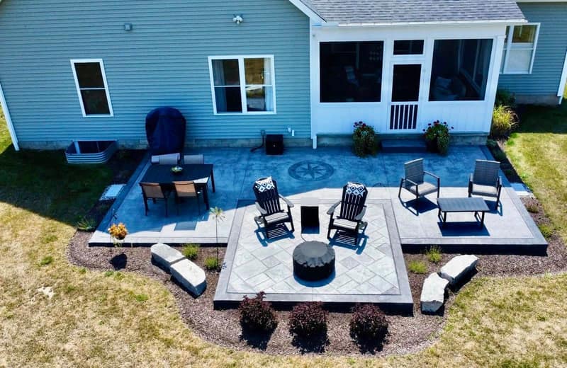 Stamped patio with fire pit seating and a compass medallion