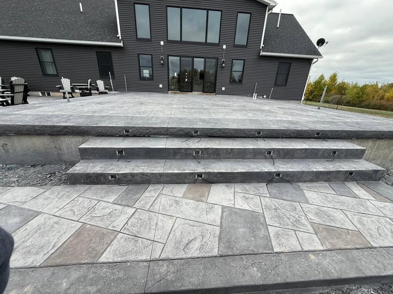 Raised stamped patio faced with stacked stone