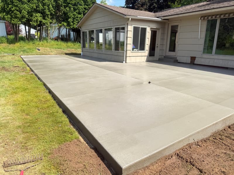 Large brushed (broom-finish) concrete patio