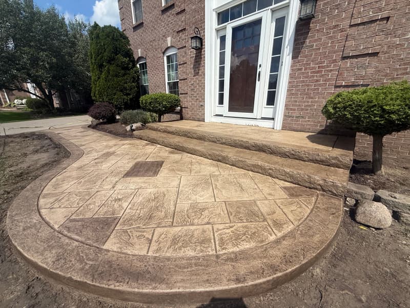 Curved stamped front stoop at a brick home