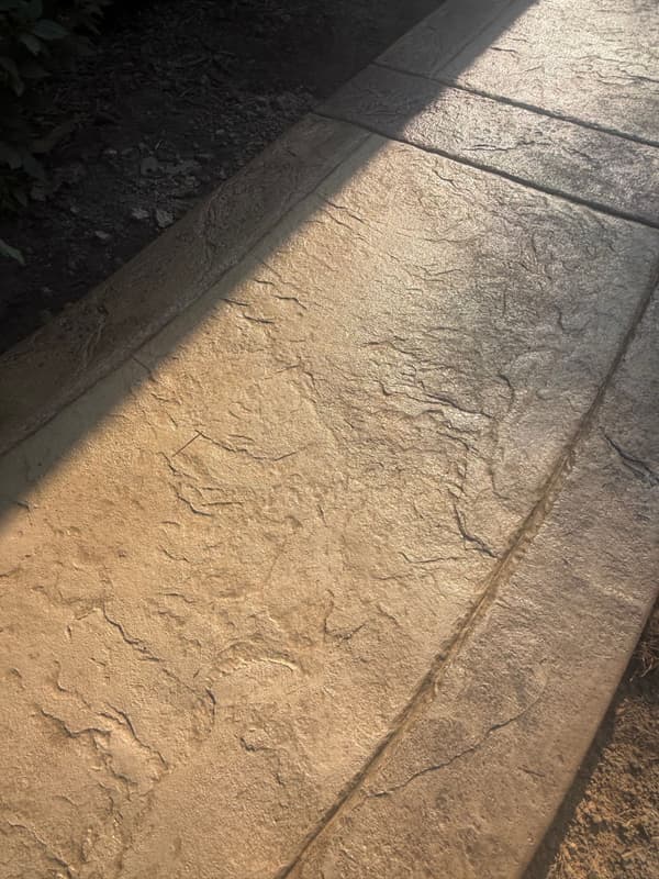 Close-up of stamped stone texture and a hand-tooled joint line