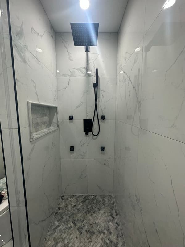 Marble-look tile shower with rain head